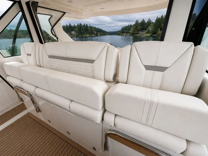 Slide: The Image of Interior of 2023 Tiara Yachts 48 LS with luxurious white seating. - 7