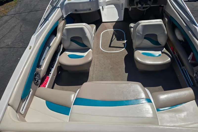 Slide: The Image of Interior of a 1996 Four Winns 200 Horizon boat with beige and blue seating. - 11