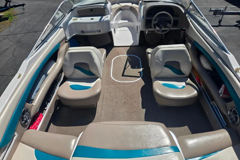 Slide: The Image of Interior of a 1996 Four Winns 200 Horizon boat with beige and teal seating. - 12