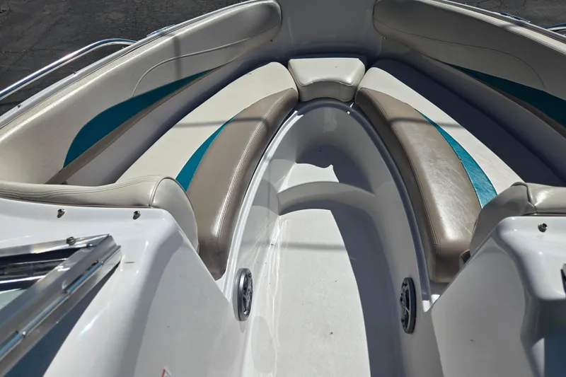 Slide: The Image of 1996 Four Winns 200 Horizon boat interior with cushioned seating and teal accents. - 13