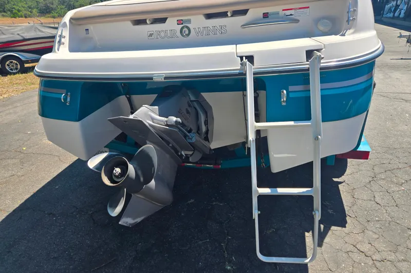 Slide: The Image of 1996 Four Winns 200 Horizon boat rear view with ladder and propeller. - 7