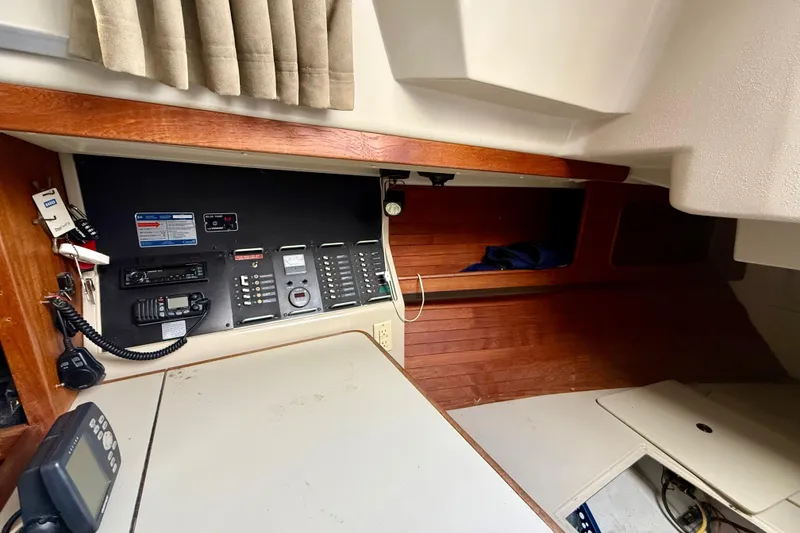 Slide: The Image of Interior view of a 1983 C&C 34 sailboat's navigation station with control panel and radio equipment. - 12