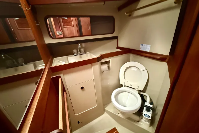 Slide: The Image of Compact bathroom in a 1983 C&C 34 sailboat with toilet and sink. - 13