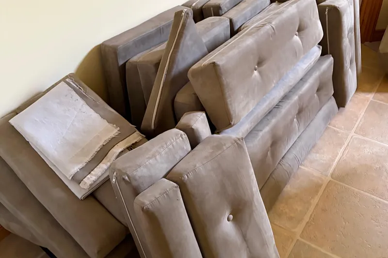 Slide: The Image of Cushions from a 1983 C&C 34 sailboat, stacked on a tiled floor. - 16