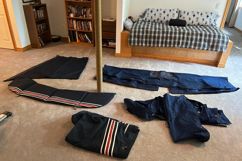 Slide: The Image of Sailboat canvas and cushions from a 1983 C&C 34 laid out in a cozy room. - 18