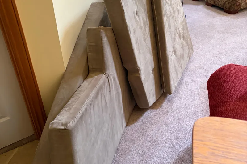 Slide: The Image of Cushions from a 1983 C&C 34 sailboat, stacked indoors on carpet. - 19