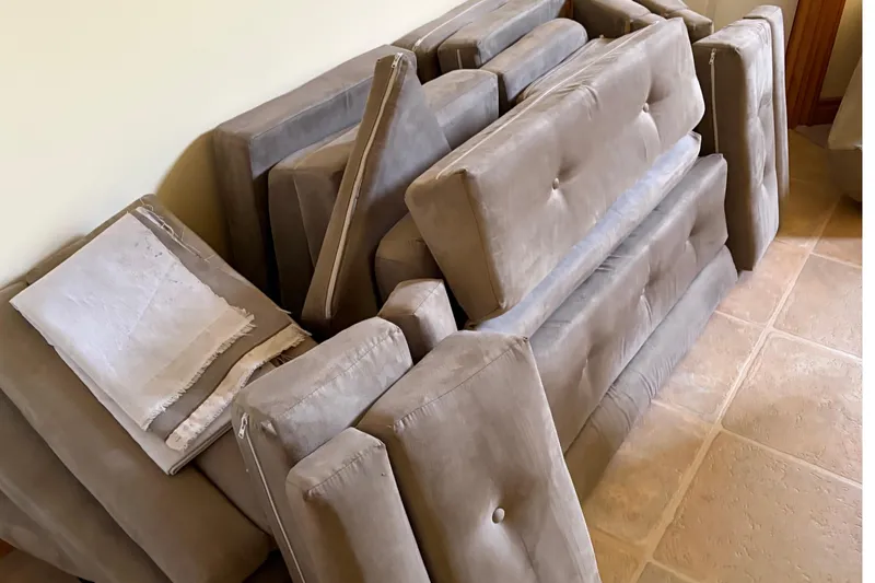 Slide: The Image of Cushions from a 1983 C&C 34 sailboat, stacked on a tiled floor. - 20
