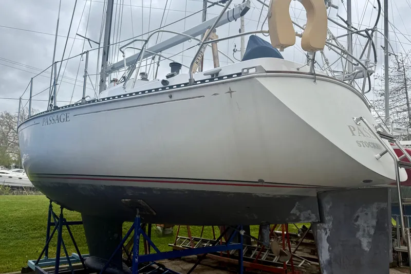 Slide: The Image of 1983 C&C 34 sailboat named "Passage" on stands, ready for maintenance. - 3