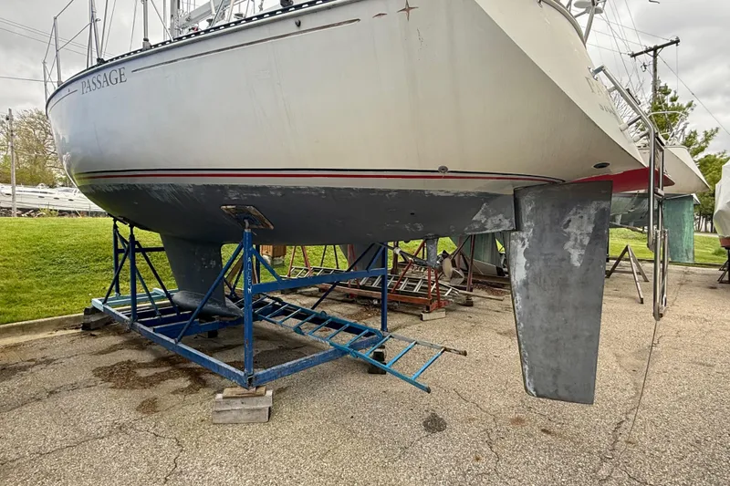 Slide: The Image of 1983 C&C 34 sailboat on stands, showing hull and keel in a boatyard. - 4