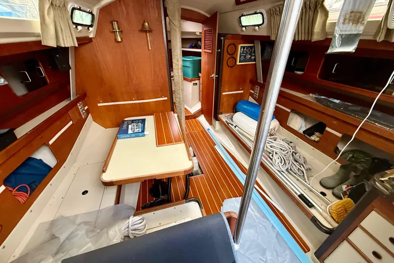 Slide: The Image of Interior of a 1983 C&C 34 sailboat with wood paneling and nautical equipment. - 7