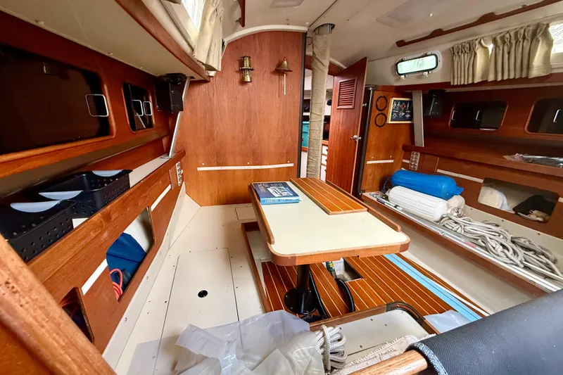 Slide: The Image of Interior of a 1983 C&C 34 sailboat with wooden furnishings and nautical equipment. - 8