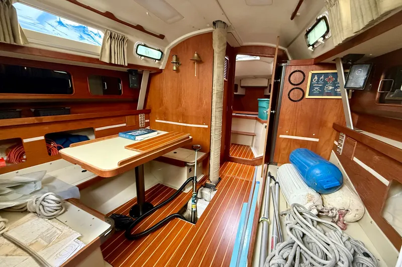 Slide: The Image of Interior of a 1983 C&C 34 sailboat with wooden finishes and nautical equipment. - 9