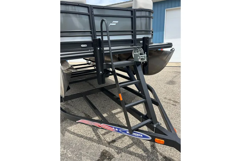 Slide: The Image of 2022 Starcraft CX 21 C pontoon boat on trailer, featuring a sturdy ladder. - 11