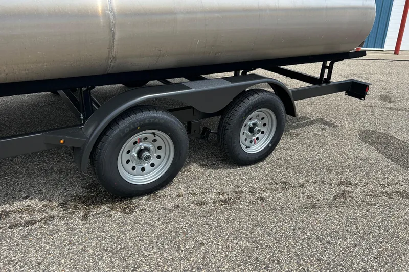 Slide: The Image of Trailer wheels of a 2022 Starcraft CX 21 C on asphalt surface. - 13