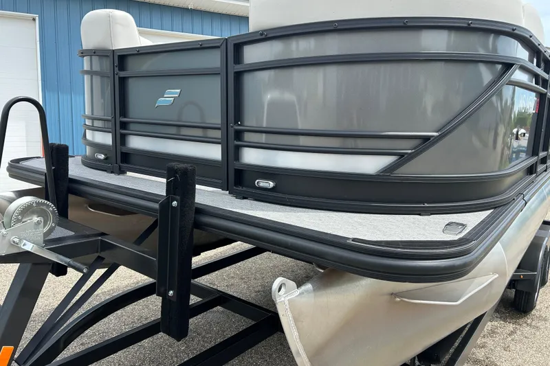 Slide: The Image of 2022 Starcraft CX 21 C pontoon boat on trailer, featuring sleek design and modern railing. - 16