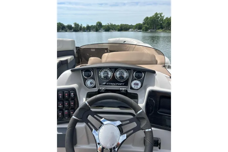 Slide: The Image of Cockpit view of 2022 Starcraft CX 21 C boat on a serene lake. - 18