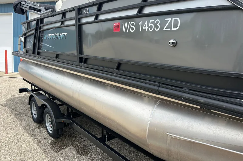 Slide: The Image of 2022 Starcraft CX 21 C pontoon boat on trailer, side view with registration number. - 4