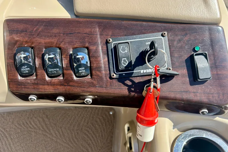 Slide: The Image of Control panel of a 2012 Bennington 2250RCL boat with switches and ignition key. - 16