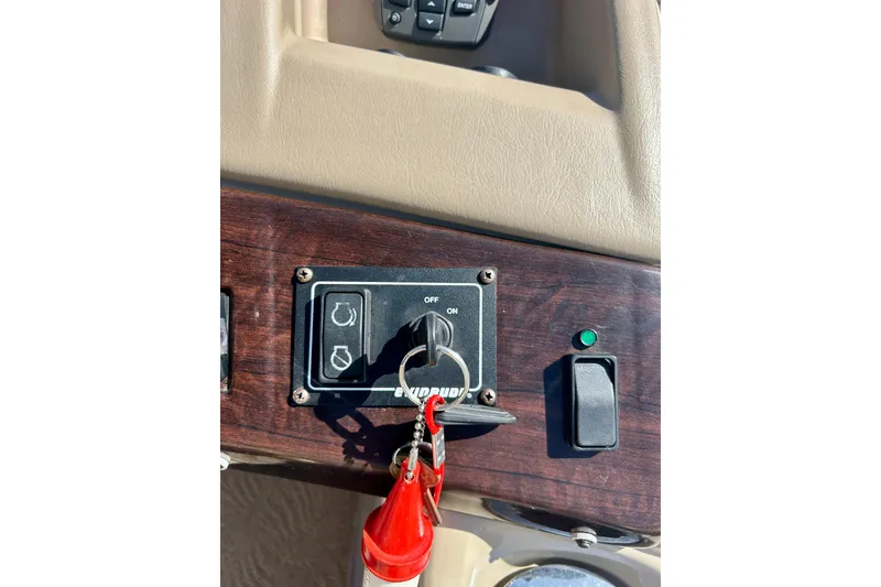 Slide: The Image of Dashboard of a 2012 Bennington 2250RCL boat with ignition key and controls. - 18