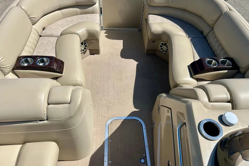 Slide: The Image of Luxurious interior of a 2012 Bennington 2250RCL pontoon boat with beige seating and cup holders. - 21