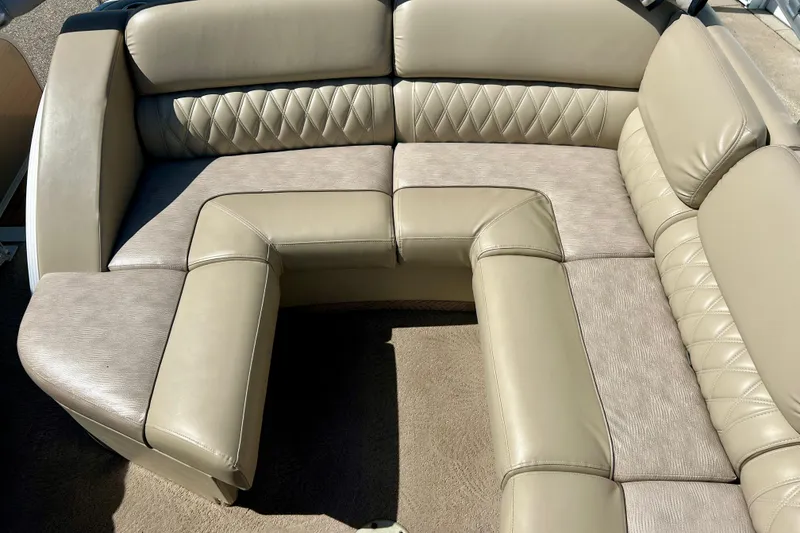 Slide: The Image of Luxurious beige seating on a 2012 Bennington 2250RCL boat, featuring diamond-patterned upholstery. - 25
