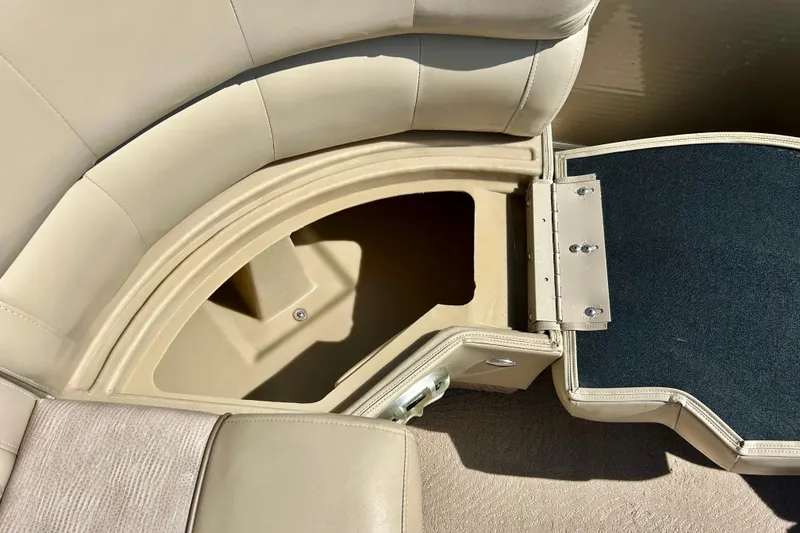 Slide: The Image of Open storage compartment in 2012 Bennington 2250RCL boat with beige seating. - 37