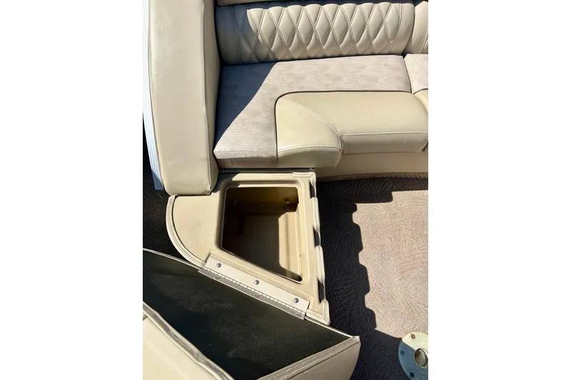 Slide: The Image of 2012 Bennington 2250RCL boat seat with open storage compartment. - 38