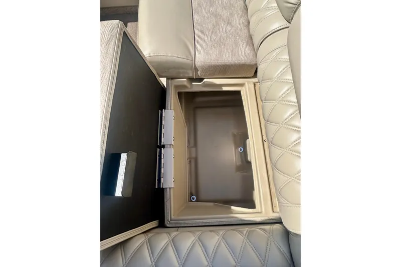 Slide: The Image of Open storage compartment in 2012 Bennington 2250RCL boat with beige quilted upholstery. - 40