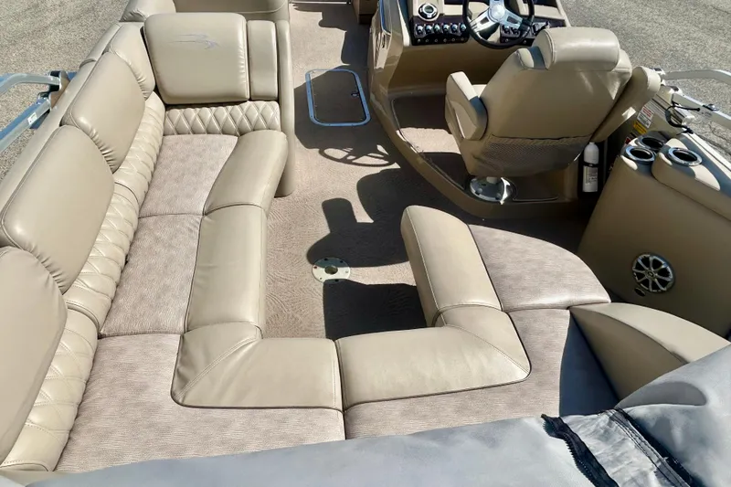 Slide: The Image of Interior of a 2012 Bennington 2250RCL boat with beige seating and steering console. - 42