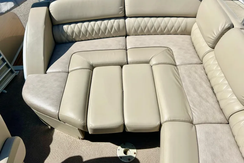 Slide: The Image of Luxurious beige seating on a 2012 Bennington 2250RCL boat, featuring diamond-patterned upholstery. - 43