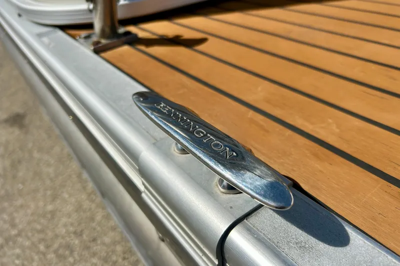 Slide: The Image of 2012 Bennington 2250RCL boat cleat on wooden deck, close-up view. - 47