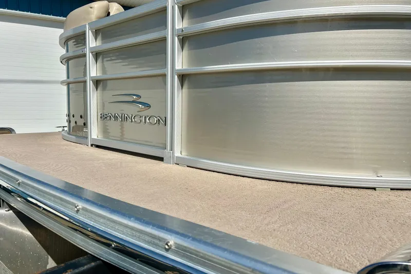 Slide: The Image of 2012 Bennington 2250RCL pontoon boat, silver exterior, close-up view. - 49