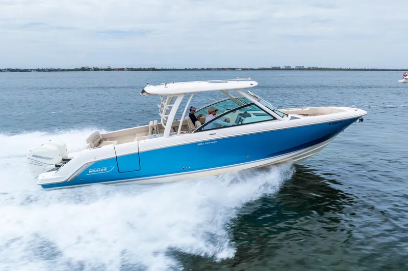 Slide: The Image of 2017 Boston Whaler 320 Vantage cruising on open water, showcasing sleek design and performance. - 13