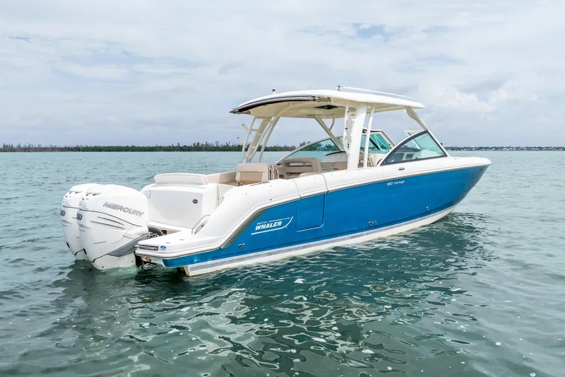 Slide: The Image of 2017 Boston Whaler 320 Vantage boat on calm water, featuring twin Mercury engines. - 14