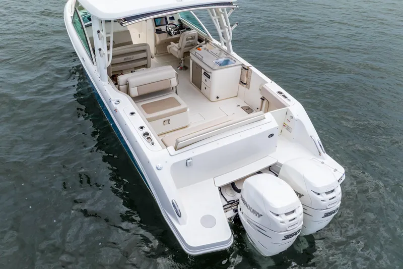 Slide: The Image of 2017 Boston Whaler 320 Vantage boat with dual Mercury engines on open water. - 18