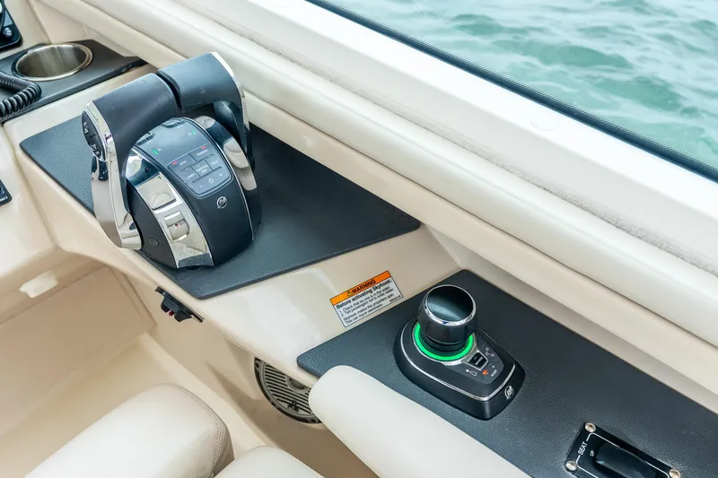 Slide: The Image of Control panel of a 2017 Boston Whaler 320 Vantage boat, featuring throttle and joystick. - 20