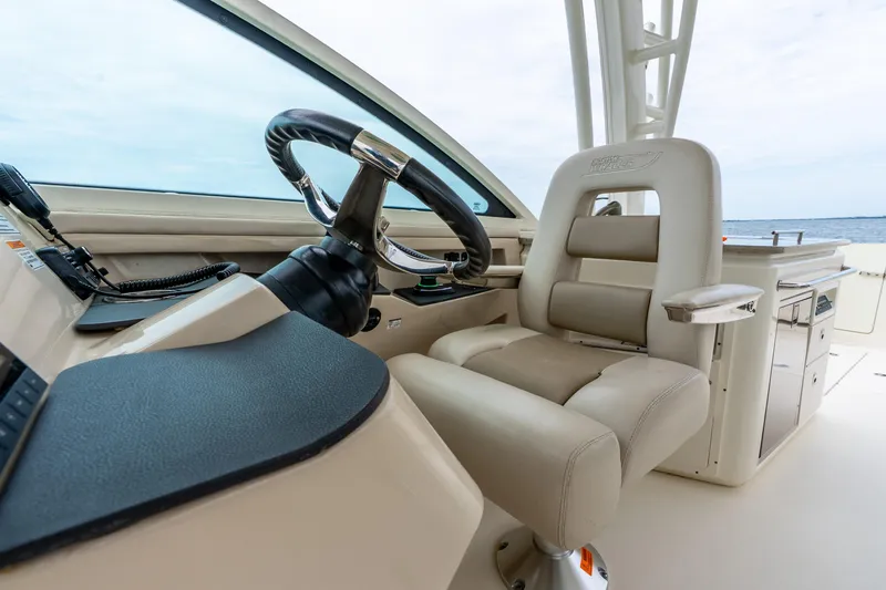 Slide: The Image of 2017 Boston Whaler 320 Vantage helm with luxurious seating and steering wheel. - 23