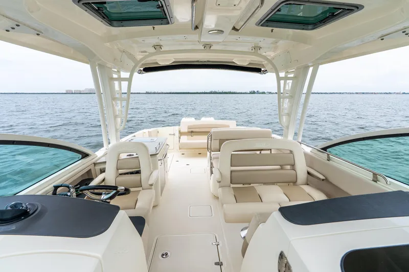 Slide: The Image of 2017 Boston Whaler 320 Vantage boat interior with seating, helm, and ocean view. - 26