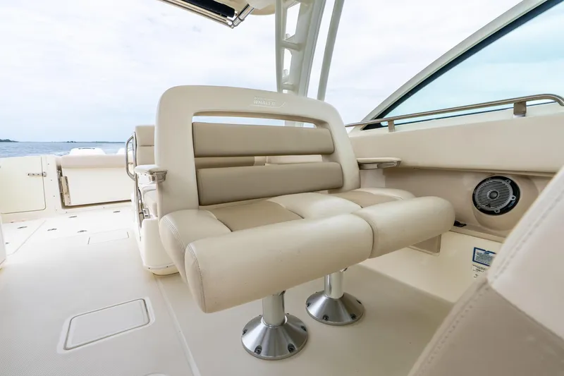 Slide: The Image of 2017 Boston Whaler 320 Vantage boat interior with beige seating and ocean view. - 27