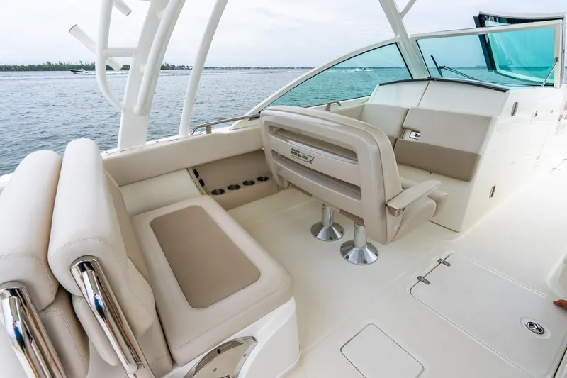 Slide: The Image of 2017 Boston Whaler 320 Vantage boat interior with beige seating and ocean view. - 28