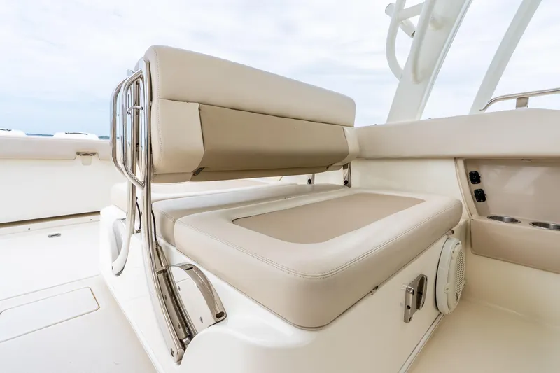 Slide: The Image of 2017 Boston Whaler 320 Vantage boat interior with beige seating and stainless steel accents. - 29