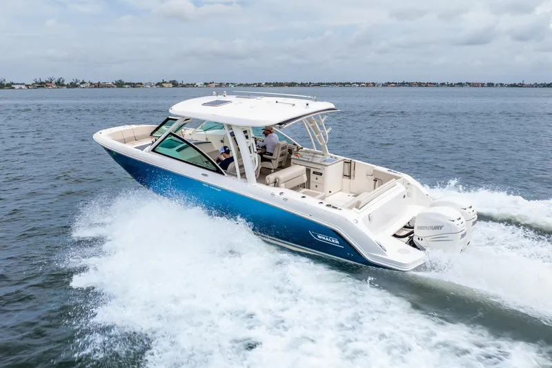 Slide: The Image of Manufacturer Provided Image: 2017 Boston Whaler 320 Vantage boat with passengers on a calm lake. - 3