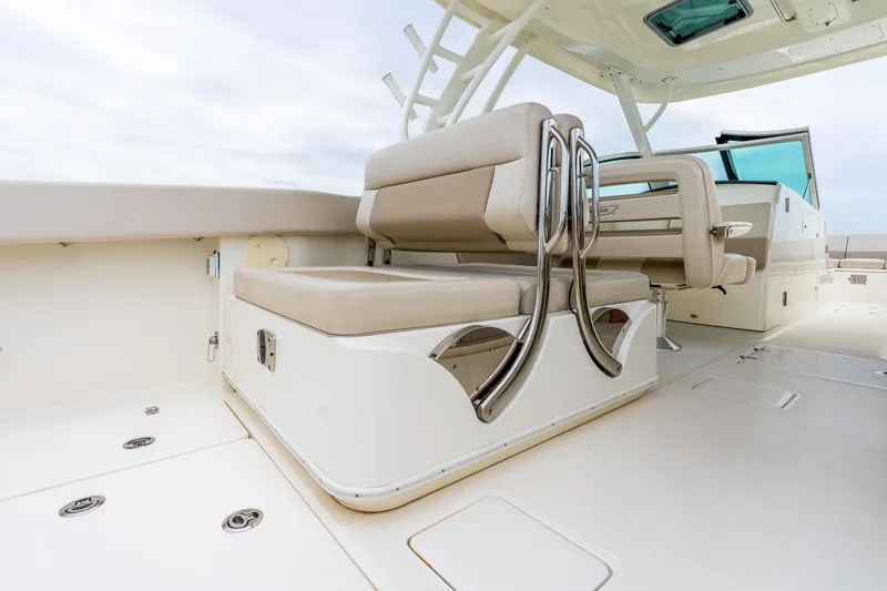 Slide: The Image of 2017 Boston Whaler 320 Vantage boat interior with beige seating and stainless steel accents. - 30