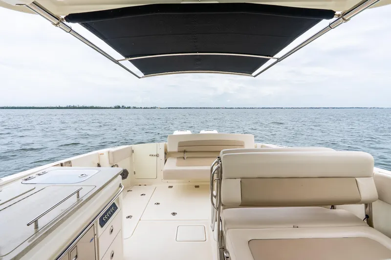 Slide: The Image of 2017 Boston Whaler 320 Vantage boat interior with ocean view and seating area. - 31