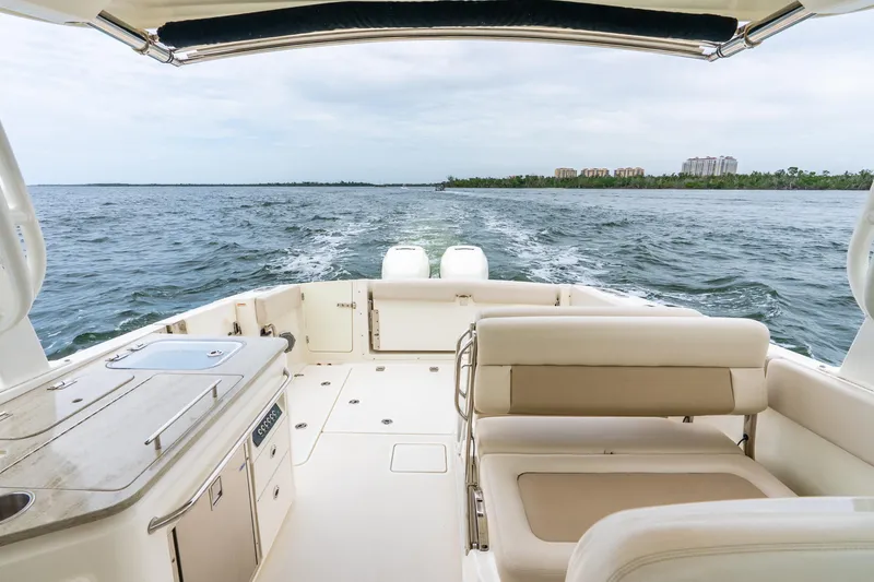 Slide: The Image of 2017 Boston Whaler 320 Vantage boat interior with ocean view and seating area. - 32