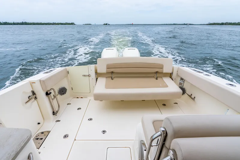 Slide: The Image of 2017 Boston Whaler 320 Vantage boat interior with seating, cruising on open water. - 33
