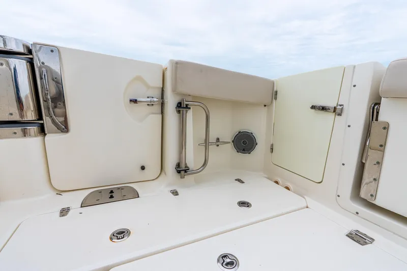 Slide: The Image of 2017 Boston Whaler 320 Vantage boat interior with stainless steel fixtures and storage compartments. - 35
