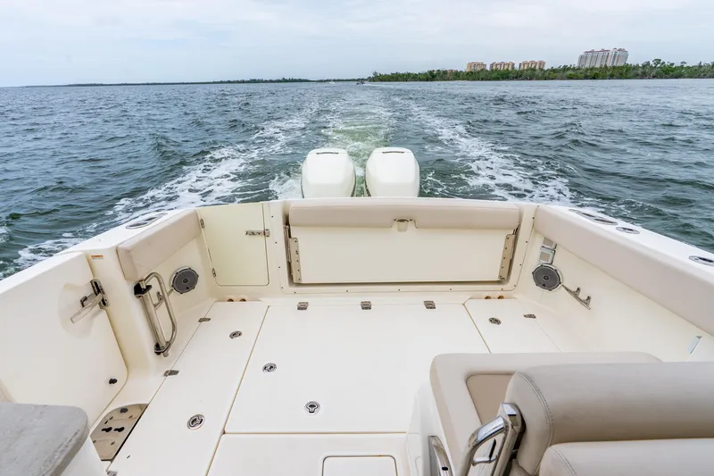 Slide: The Image of 2017 Boston Whaler 320 Vantage boat deck with dual engines on open water. - 36