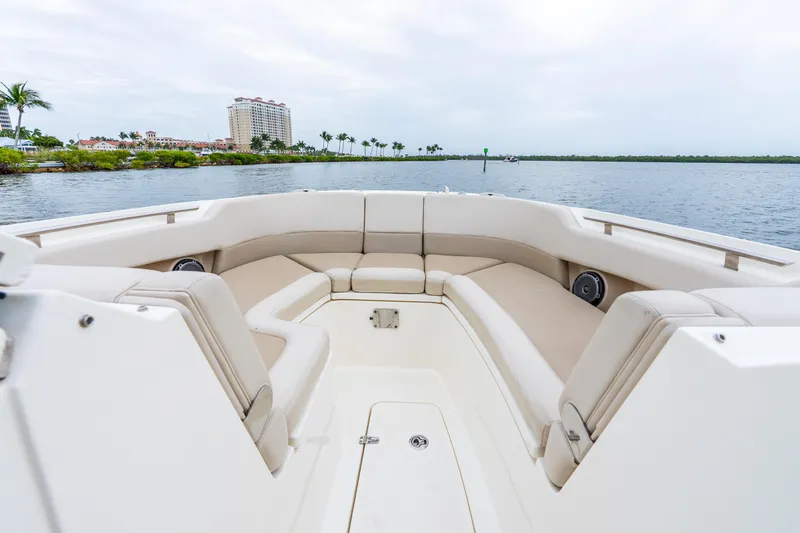 Slide: The Image of 2017 Boston Whaler 320 Vantage boat interior with spacious seating, overlooking calm waters and distant buildings. - 37