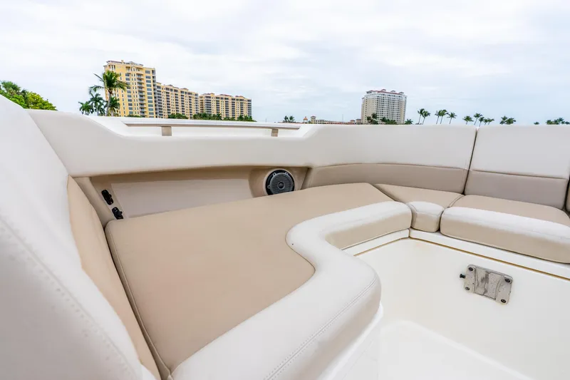 Slide: The Image of Luxurious seating on 2017 Boston Whaler 320 Vantage boat with cityscape background. - 38